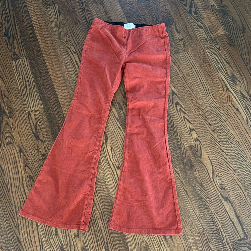 Burnt orange/rust colored corduroy bell bottom pant.